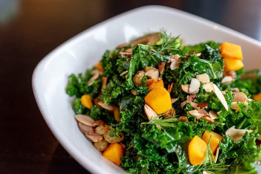 Kale Salad · Shaved broccoli, farro, toasted almonds, fresh herbs, almond-lime dressing, oranges, and crispy wontons.