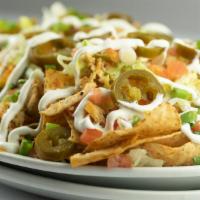 Chicken Cheese Nachos · Freshly fried tortilla chips layered with our own queso sauce, cheddar, and pepper jack chee...