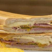 Cuban Sandwich · Ham, pork, swizz cheese, picles, mustard, and Cuban bread.
