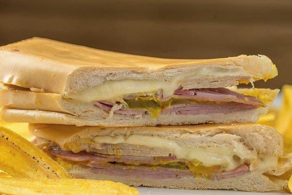 Cuban Sandwich · Ham, pork, swizz cheese, picles, mustard, and Cuban bread.