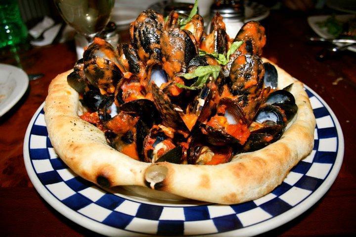 Mussels Possilippo · Mussels marinara served in a freshly-baked bread basket.