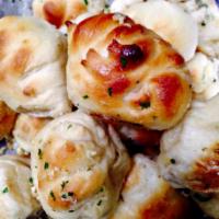 6 Piece Garlic Knots · Twists of dough covered with garlic and Romano cheese.