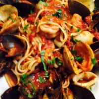 Seafood Combination - Dinner · Made for the seafood lover: clams, mussels, shrimp, and calamari in a marinara sauce over li...