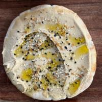 Hummus and Pita · Hummus spread over pita with olive oil and everything bagel spice