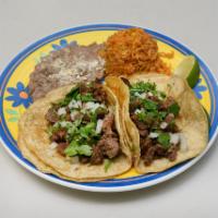 2 Tacos Dinner · Cilantro, onion, lettuce and tomato. Served with rice and beans.