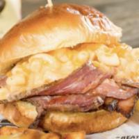 Mac n Brisket Sandwich  · Delicious smoked brisket, topped with mac and cheese, cheddar cheese and BBQ sauce.