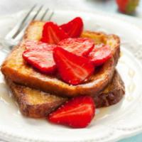Strawberry French Toast · 2 pieces. 2 slices of challah bread soaked in eggs and milk, then fried topped with powdered...