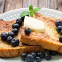 Blueberry French Toast  · 2 pieces. 2 slices of challah bread soaked in eggs and milk, then fried topped with powdered...