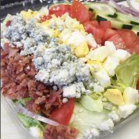 Cobb Salad · Romaine and iceberg mix with boiled eggs, bacon, cucumber, bleu cheese crumbles, tomato, and...