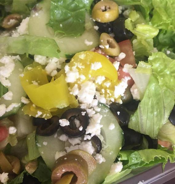 Greek Salad · Romaine lettuce with black olives, green olives, tomato, cucumber, banana peppers, red onion, and feta cheese, served with aegean salad dressing.