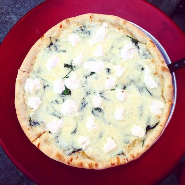 White Pizza · Roasted garlic and shallot base with mozzarella, fresh spinach, and ricotta cheese. Vegetarian.
