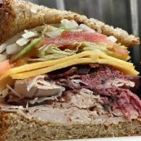 Ultimate Club Sandwich · Turkey, roast beef, cheddar cheese, mayo, bacon, lettuce, tomato and onion.