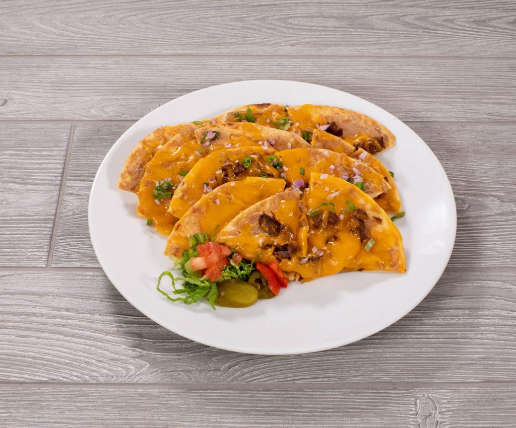 Super Nachos · Your choice of beef fajita, chicken fajita or chopped brisket. Served with lettuce, tomato and guacamole.