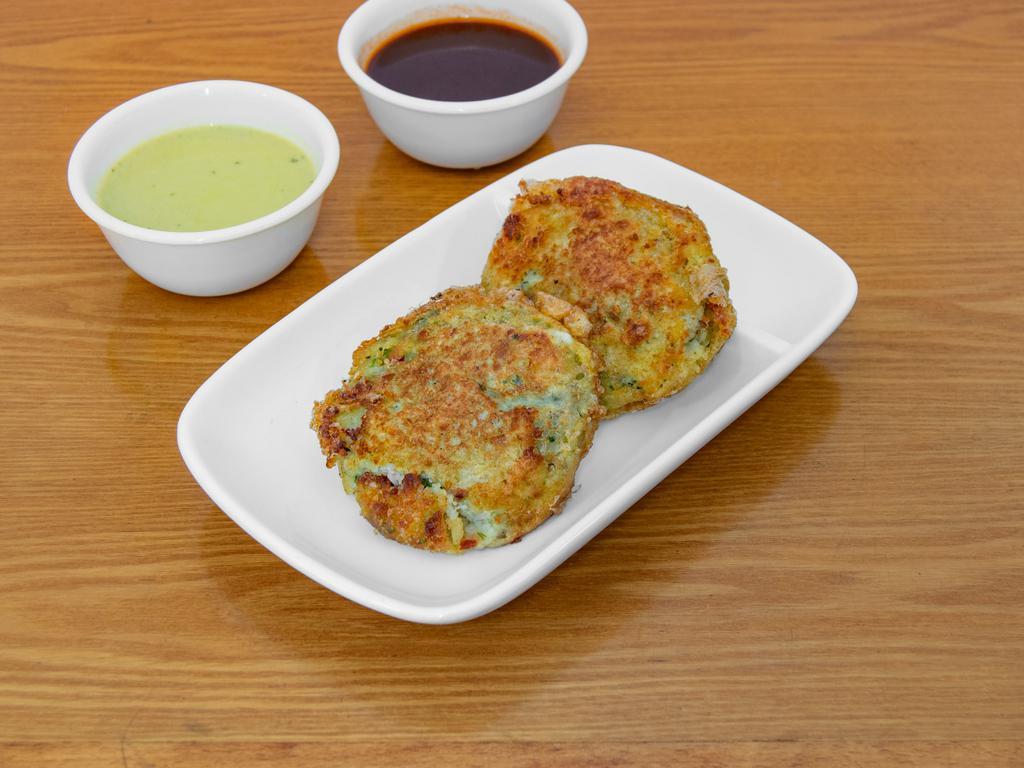 Potato Patties · Mashed potato patties mixed with coriander, peas, and spices, fried in oil.