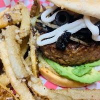 The Tunnel Vision Beyond Burger · Grilled mushrooms, grilled onions and black olives. Topped with an avocado sauce and our hou...