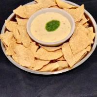Chips and Queso · Fresh daily made queso serve with tortilla chips and a cilantro chutney.