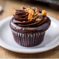 The Ron Bennington Cupcake · Chocolate cake, peanut butter filling, chocolate ganache and crushed butterscotch topping.