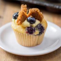 Blueberry Cheesecake · Vanilla cake with cheesecake baked in, cinnamon graham cracker pieces, pastry cream and glaz...