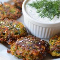 Zucchini Croquettes · Comes with feta and kefalograviera cheese and fresh herbs. Served with yogurt garlic sauce.