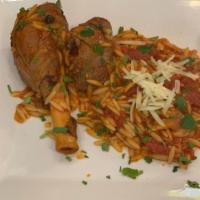 Lamb Yiouvetsi · Slow braised lamb shank served with tomato orzo.