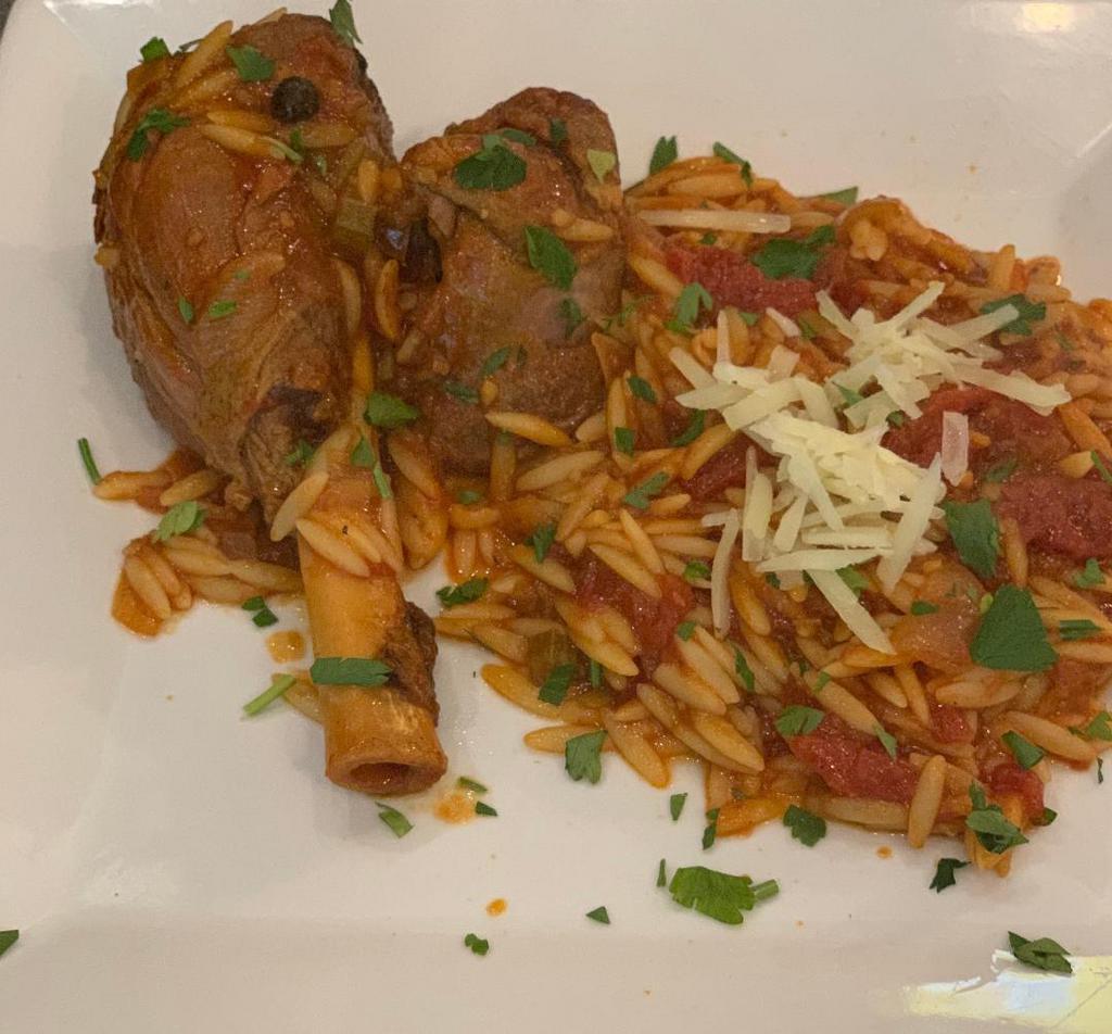 Lamb Yiouvetsi · Slow braised lamb shank served with tomato orzo.