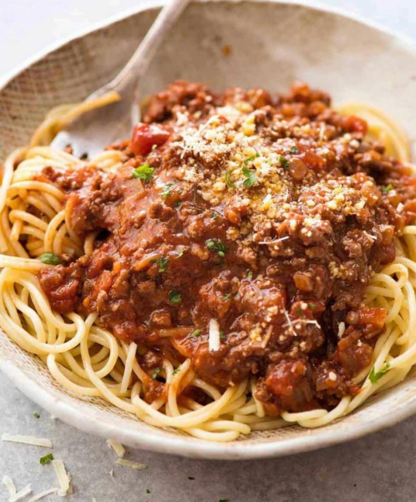 Pasta Bolognese · Served with choice of pasta, salad, bread and butter and Romano cheese.