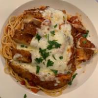 Chicken Parmigiana · Chicken cutlet with marinara sauce and mozzarella over pasta.