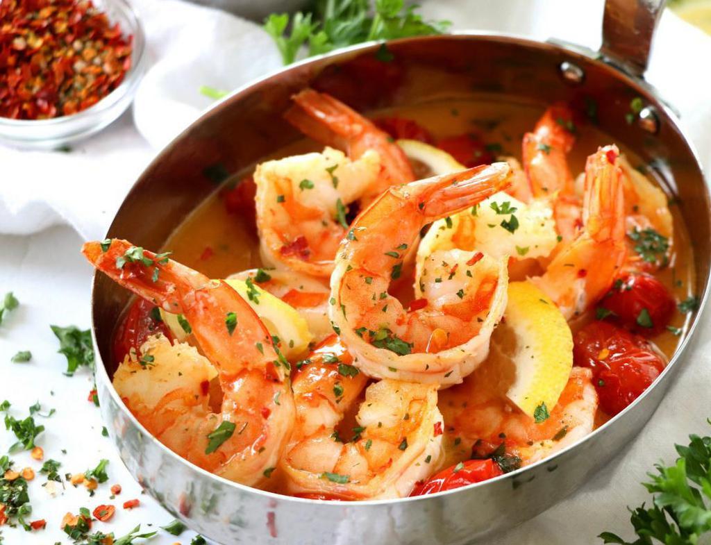 Garides Santorini · Wild jumbo shrimp in a light feta tomato sauce and orzo pasta.