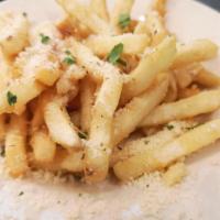 Greek Fries · Fried potatoes dusted with grated cheese, Greek oregano, and Kefalograviera cheese.