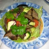 Beef Salad · Yum Nua. Sliced BBQ beef mixed with chili, onions, tomatoes and cucumbers in spicy lime dres...