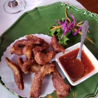 Moo Dad Deow · Crispy pork strip marinated in garlic sauce, served with special spicy sauce.