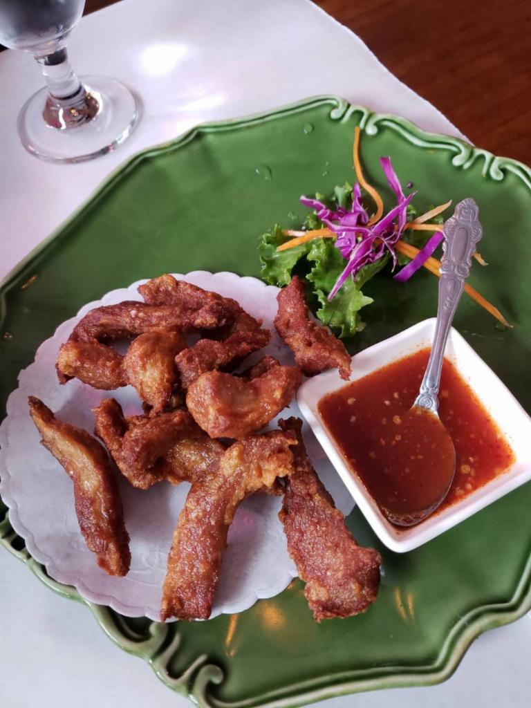 Moo Dad Deow · Crispy pork strip marinated in garlic sauce, served with special spicy sauce.