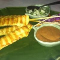 Chicken Satay · Marinated skewered Thai BBQ chicken served with peanut sauce and cucumber sauce on the side....