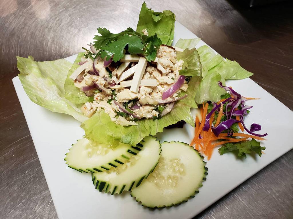 Larb Tofu · Cooked minced tofu, mushroom, mixed with roasted rice power, red onions, mint leaves and scallions in spicy lime dressing.