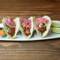 Grilled Fish Tacos · fresh cod, chipotle & homney, pickled onions, radish