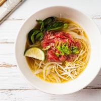 P1. Classic Pho Noodle Soup · Rare eye round, with rice noodle, served with beef broth, onions, scallions.