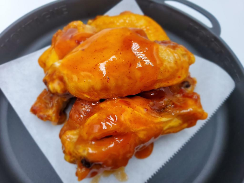 Mango Habanero Wings · Five bone-in jumbo wings with mango habanero sauce.