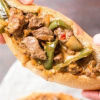 Mexican Cheese Steak with Avocado and Jalapeno · Steak, cheese, and caramelized onion sandwich.