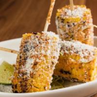 Mexican Street Corn. · Corn on the cob, chipotle aioli, cotija cheese, lime tajin