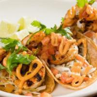 Jumbo Gulf Shrimp Tacos · Served on a soft corn tortilla, guacamole,  pico de gallo, pickled cabbage, chipotle aioli a...