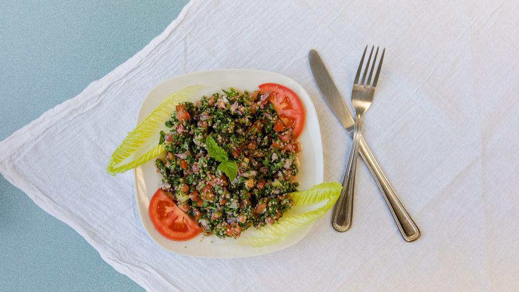 Tabbouleh Salad · Fresh chopped parsley, tomatoes and onions, with cracked wheat, freshly squeezed lemon and extra virgin olive oil.
