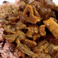 Curry Goat · Served with 2 sides; rice and peas, white rice, cabbage or collard greens 