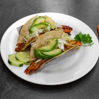 Red Snapper Taco · Lime-marinated, seared a la plancha with sauteed cabbage, crema, and a slice of avocado.
