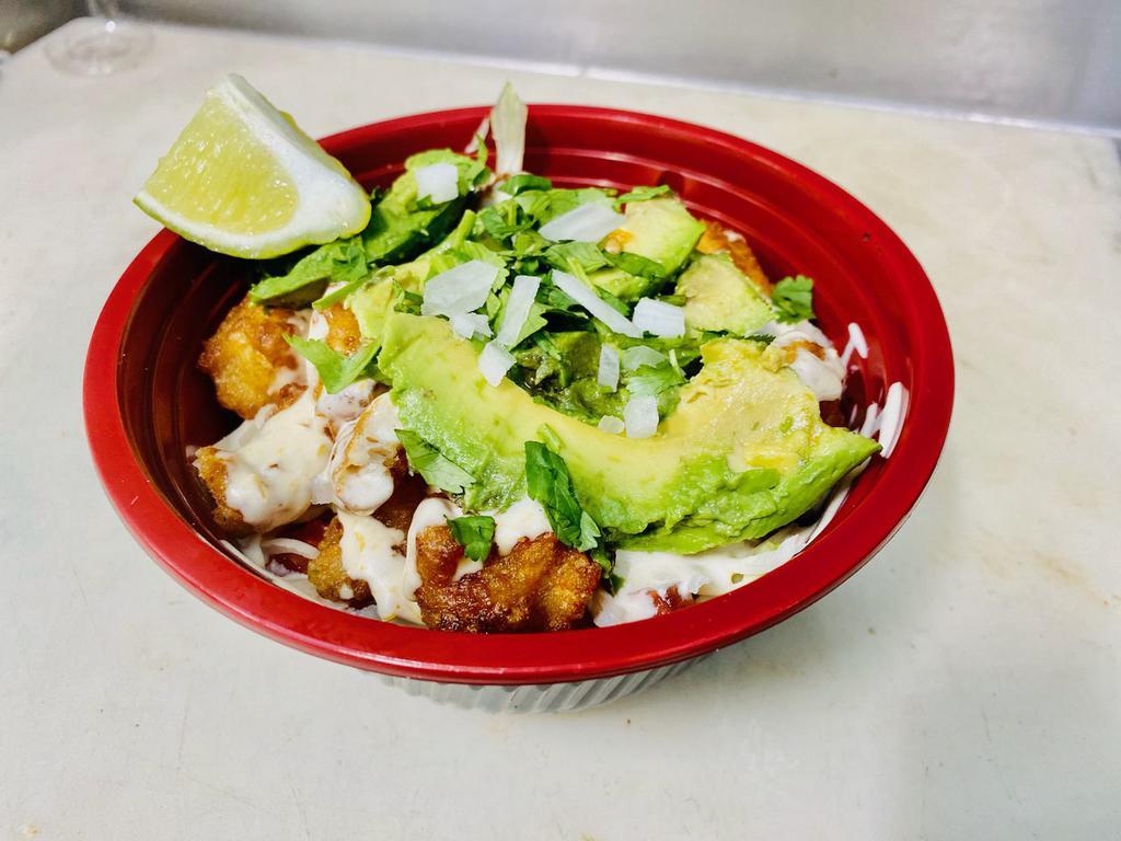 Fish Bowl · Beer battered fish on a bed of Spanish rice topped with fresh lettuce, cabbage, tomato, onion, cilantro, avocado drizzled with your choice of sauce. 