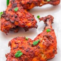 Tandoori Chicken · Spring chicken marinated in yogurt and mild spices, grilled in the clay oven. Spicy.