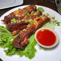 Spare ribs · Herbal marinated spare ribs pan fried, sriracha sauce.