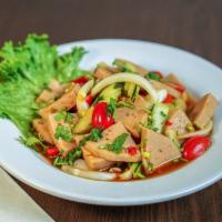 Yum moo yar · Pork sausage salad with onions, tomatoes, and cucumbers in spicy dressing. 