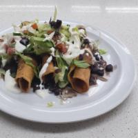 Tacos Dorado De Pollo · Flute shaped deep fried tacos with beans, sour cream, cotija cheese, lettuce, tomato & onion...