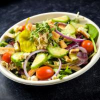 Greek Salad Bowl · Lettuce, tofu feta, hummus, olives, cucumber, tomato, red onion, pepperoncini garnished with...
