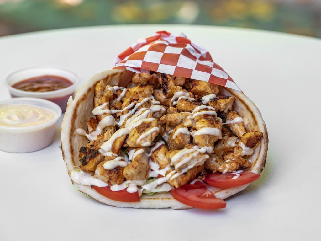 Chicken Shawarma Gyro · Seared shawarma chicken rolled with pita bread pita, lettuce, tomatoes, pickles, onions, hummus, topped with in-house garlic sauce.